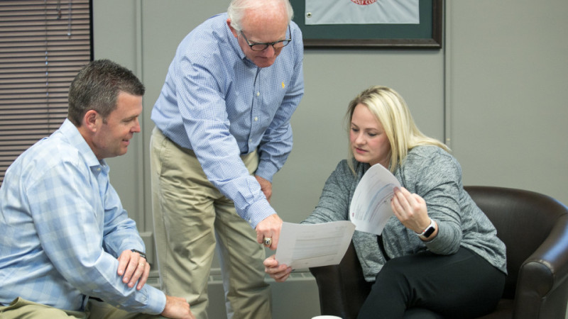 Team Members Reviewing Papers